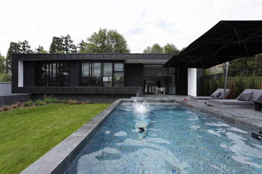 Here we have a second take, showing the pool in full use. The patio angles reflect the home itself, for unbroken style throughout.