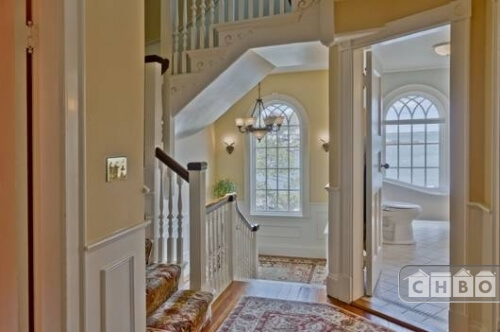 The view from the second floor landing shows a bathroom directly off the stairs and the staircase continuing up the the third floor.