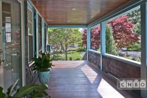 The wide front porch has recessed lighting in the polished wood ceiling. There's plenty of room for a porch swing or other seating for lazy summer afternoons or company.