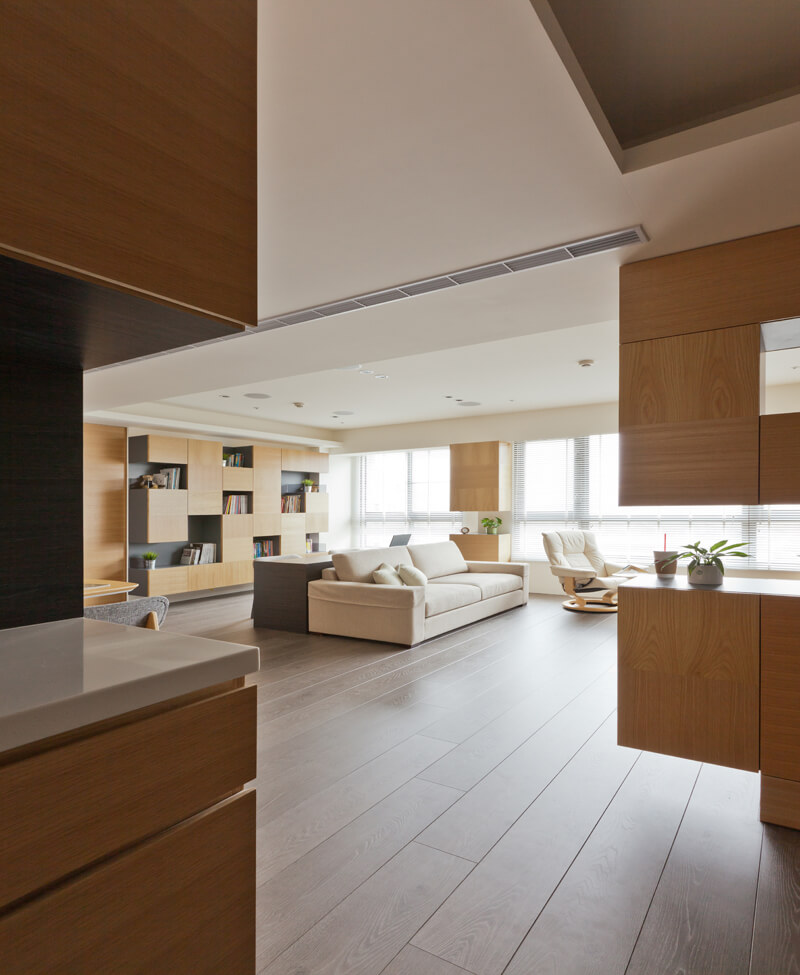 Pulling back near the entrance, we see the expanse of rich hardwood flooring spread out beneath the open design home. 