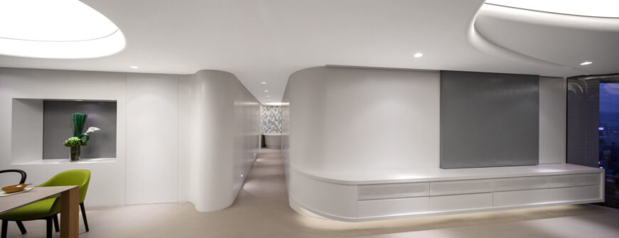 A long and slender hallway moves from the main space to peek into the bathroom. The rounded walls pulling open into the dining room and living room to display the entrance. 