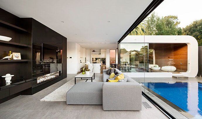 The living room flows easily into the kitchen with this open floor plan. The full height glazing gives a free and unified feeling to the house.