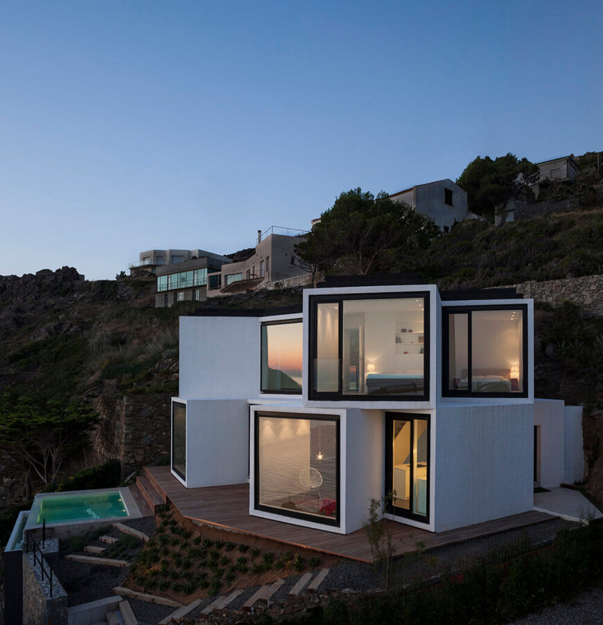 We end with a final image of the home's exterior, showing the cubes on the left side of the home and the expansive backyard patio.