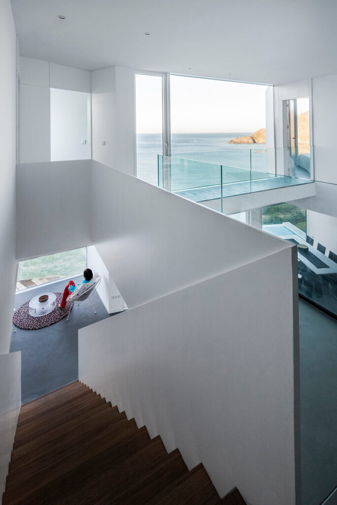 A glass-railing runs along the hallways above the two-story living room area, and into the bedrooms on the other side. Even the hallways have incredible views.