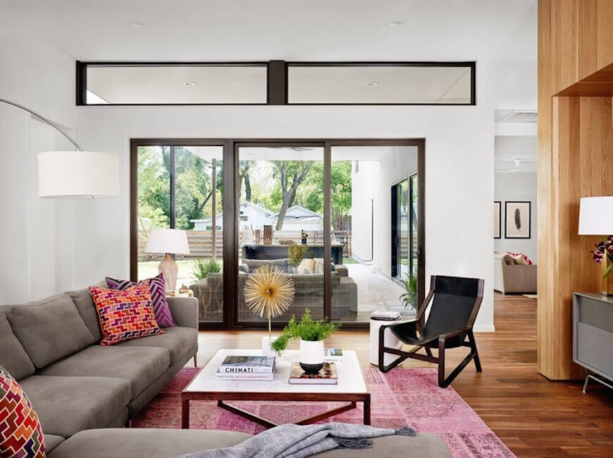 The living room is naturally lit via a broad spectrum of windows and sliding glass doors. Here we can see the vast patio, with its own set of relaxing furniture and wet bar.