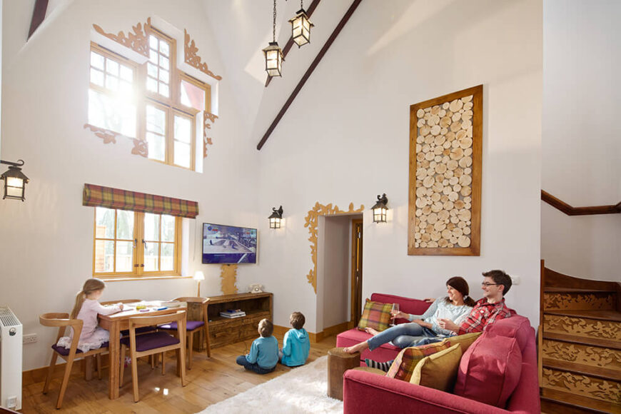 Another interior room featuring a unique set of windows, carvings, and an activity area perfect for the kids. Just look at the detail on the staircase.