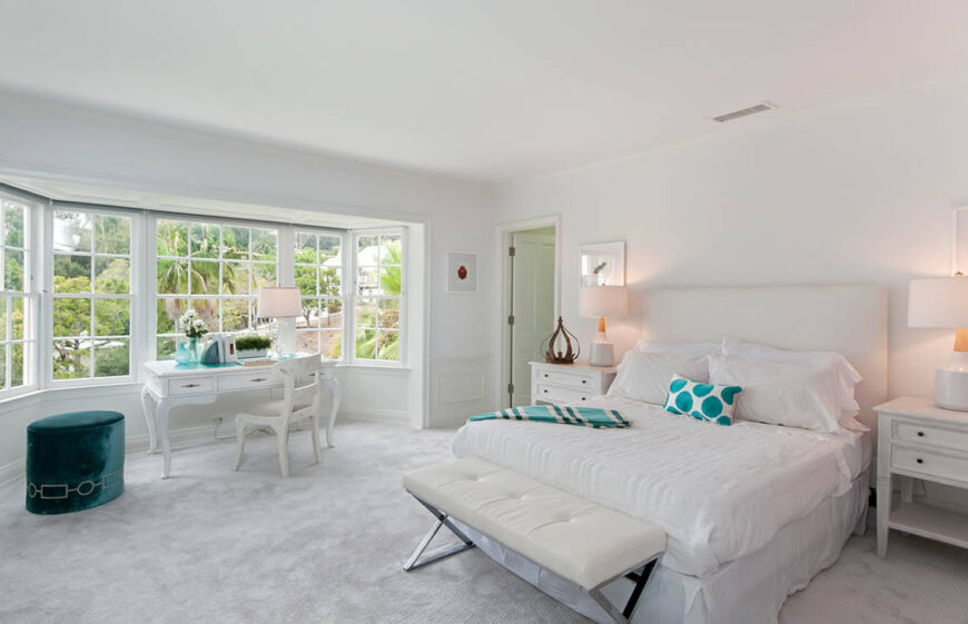 While in most bedrooms, the bed is a focal point, this bedroom chooses to allow the magnificent view from the bay windows take center stage, and the bed plays second fiddle, blending into the light color palette.