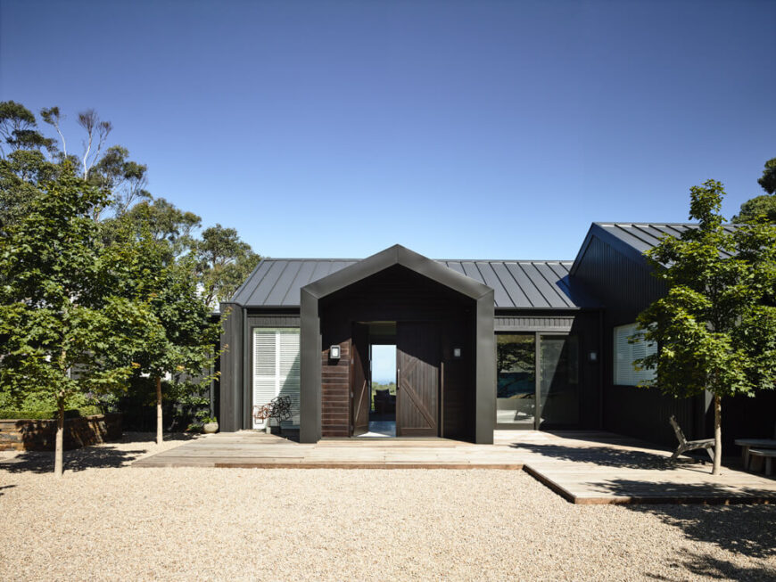 Returning to the entryway, we see how the large windows allow for continuous views right through the home to the environment beyond.