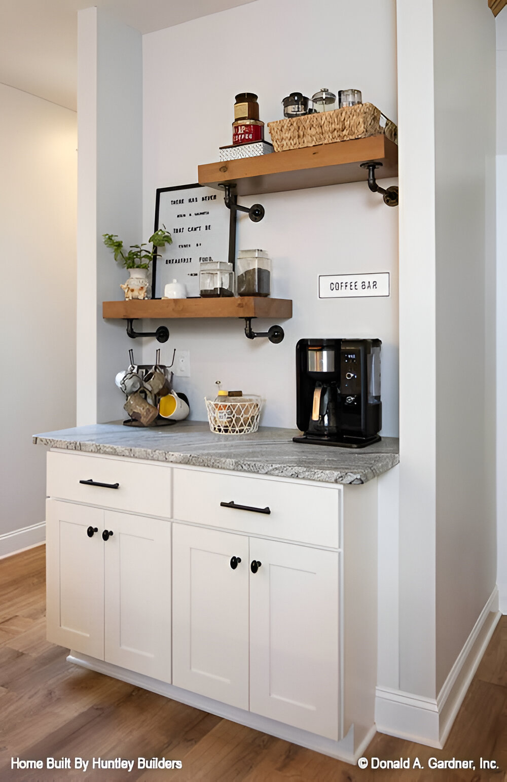 The kitchen includes a coffee bar with floating shelves and a granite countertop.