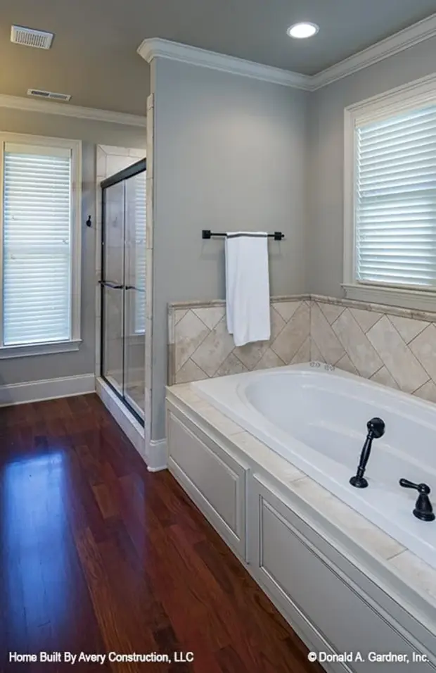 A walk-in shower and drop-in bathtub complete the primary bathroom.