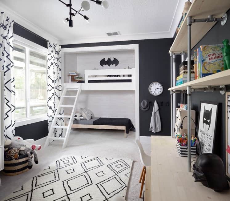 This boy's bedroom boasts Batman-inspired bedroom design with stylish beds and elegant black walls.