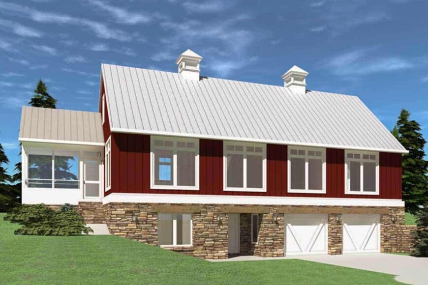 Home's side exterior view with red siding, stone basement, and a two-car garage with white doors.