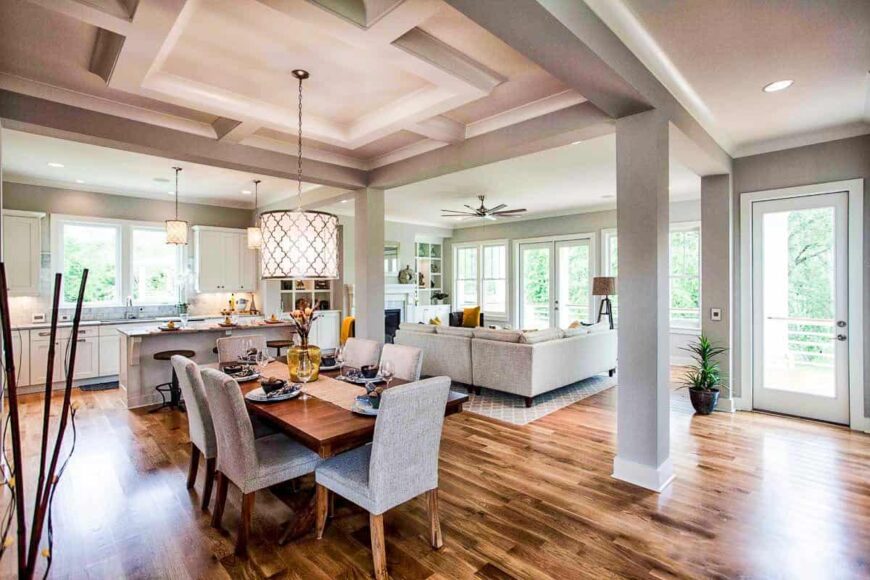 An open layout view shows the living room and eat-in kitchen with a stylish tray ceiling.