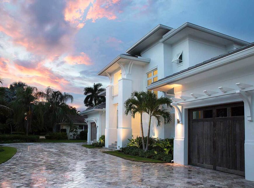 Side view of the home entry and two garages complemented with a tiled driveway.