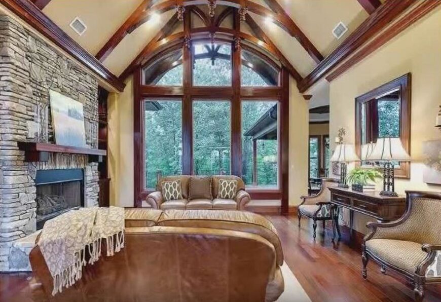 An enormous arched window on the side invites an ample amount of natural light in.