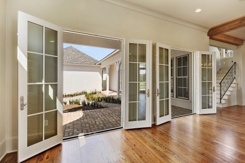 Two sets of french doors in the living room open to the back porch.