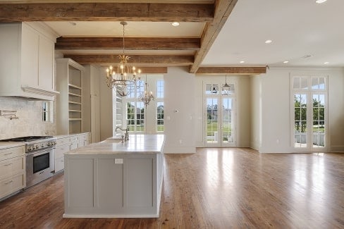 An open layout view showing the kitchen, dining area, living space, and foyer.