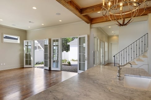 View of the living room from the kitchen showing the french doors that lead out to the rear porch.