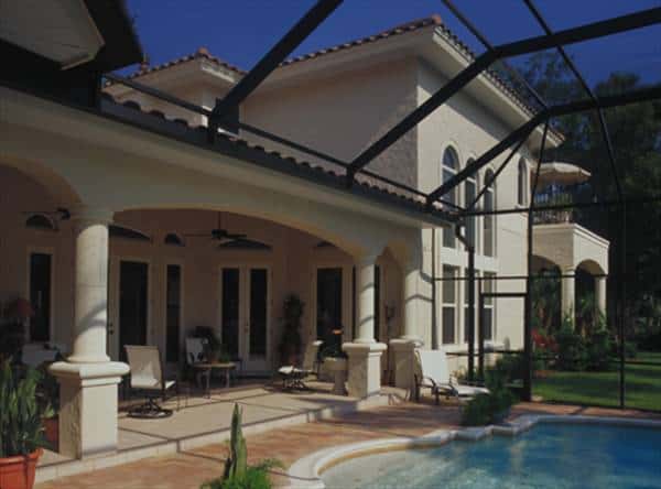 Rear porch with multiple seating and a swimming pool covered in a retractable roof.