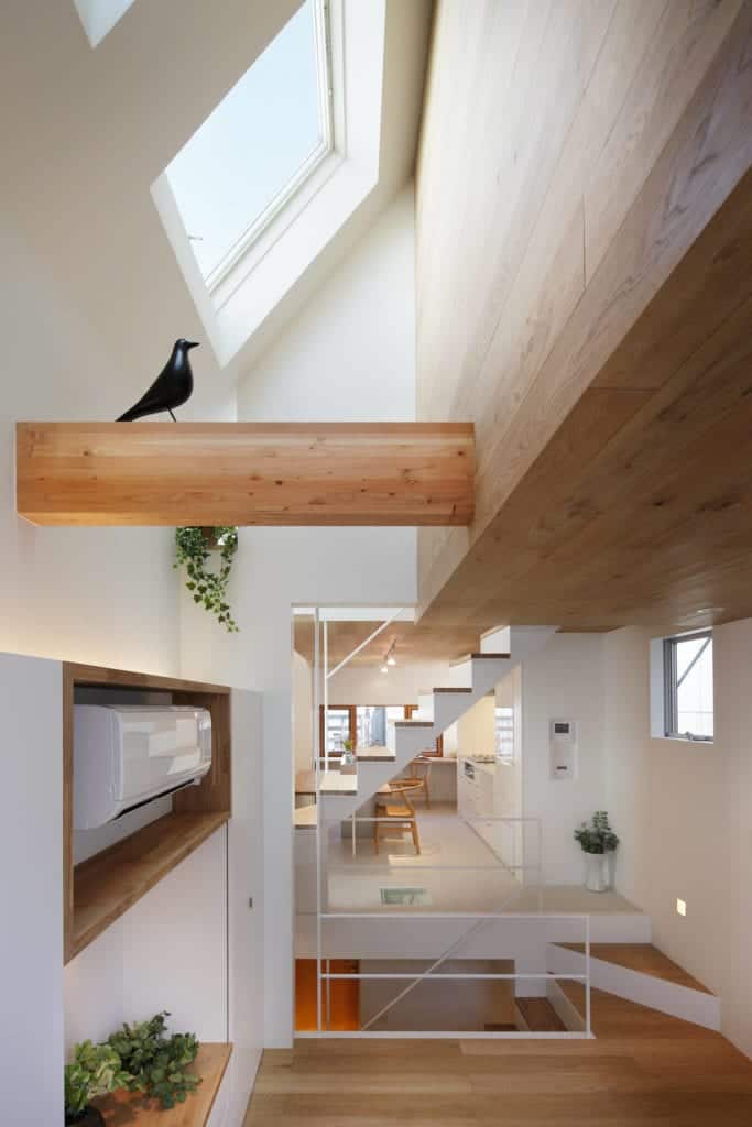 This is a closer look at the wooden beam of the wooden shed ceiling adorned with a decorative bird figurine.