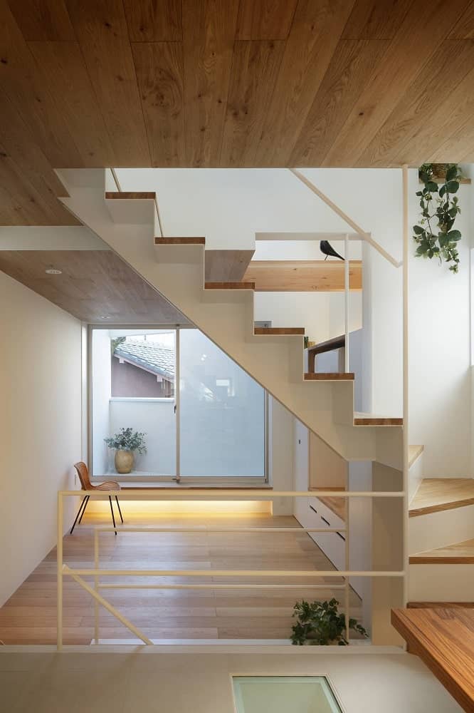 This is a look at the second floor landing with a hardwood flooring that complements the white walls and railings.