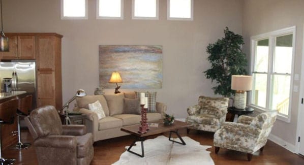 Living room with cozy seats and a wood top coffee table that sits on a cowhide area rug.