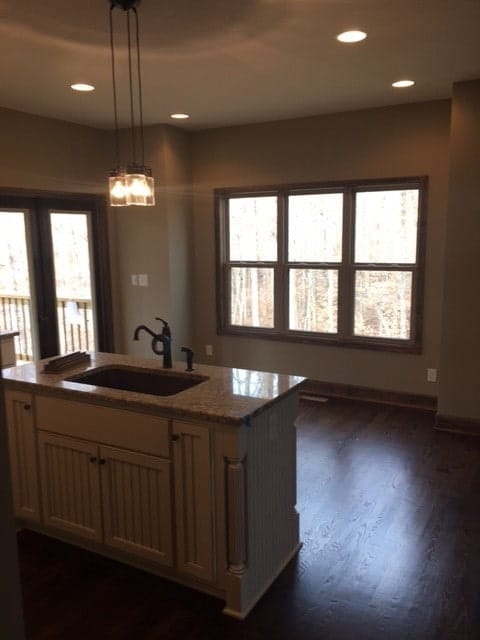 The spare space across the kitchen island is dedicated to the dining area.