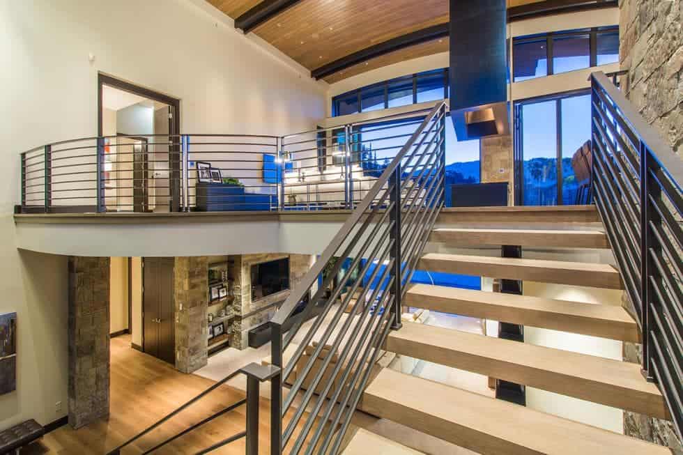 This is the view of the two levels from the vantage of the staircase. You can see here that both levels have glass walls that showcase the views outside. Image courtesy of Toptenrealestatedeals.com.