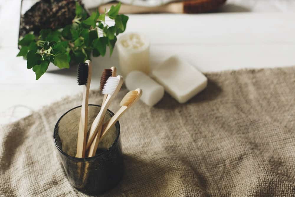 Bamboo toothbrushes on a rustic eco-friendly setup.