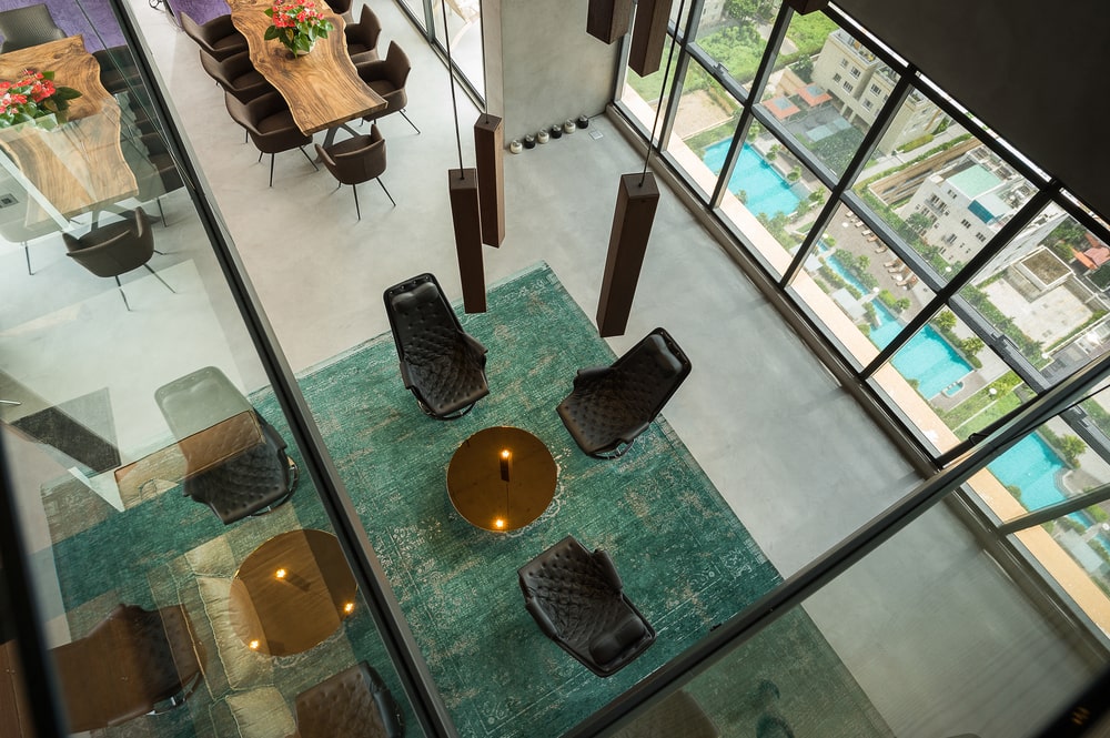 This is a view of the living room from the vantage of the indoor balcony above. showcasing the decorative lighting above the living room.