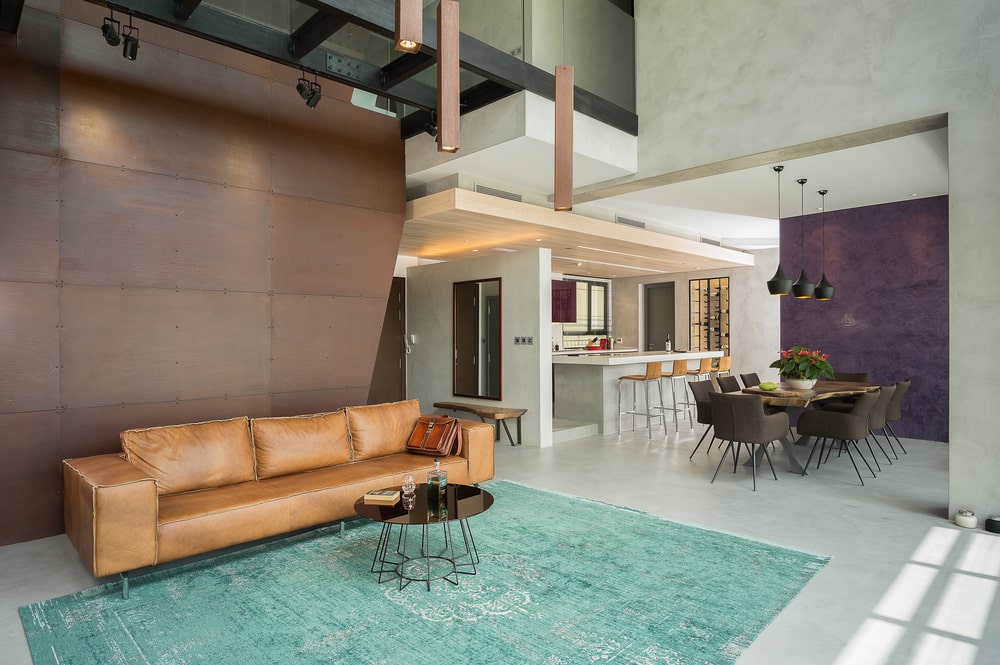 This angle of the living room showcases the bright and spacious design of the living room with open views to the dining and kitchen.