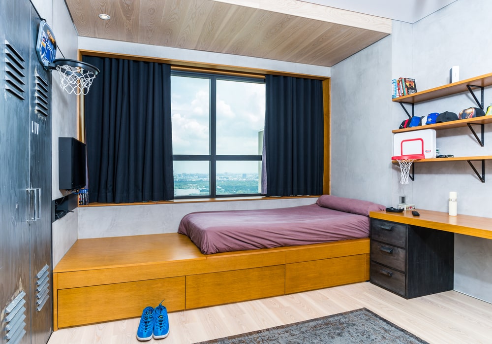 This other bedroom also has a large wooden platform with a bed cushion on top and wooden drawers underneath to maximize the storage capabilities.