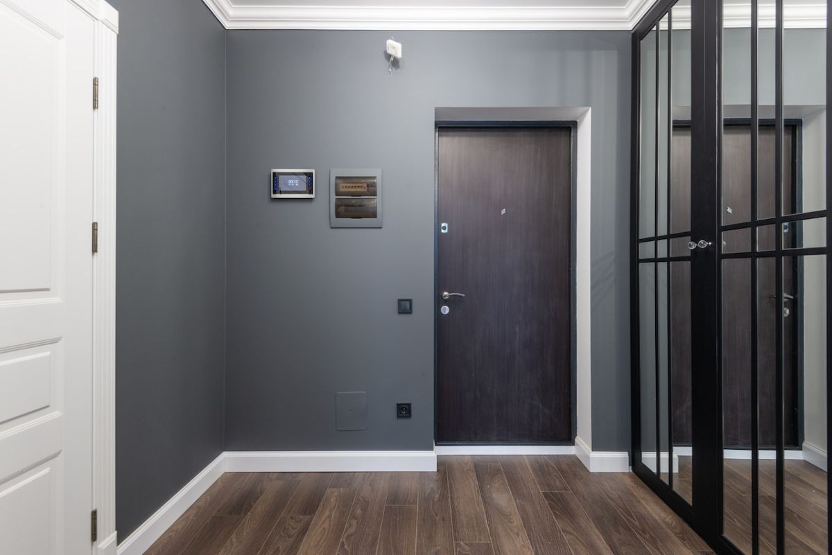 Different colors play against east other in this minimalist Pacific northwest foyer that combines rich woods tones with black, white and gray.