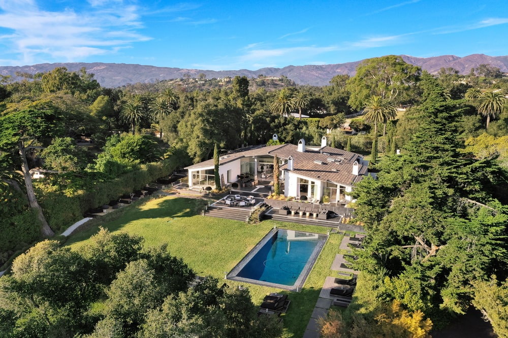 This is an aerial view of the full house showcasing the landscaping of the back of the house along with the large swimming pool. Image courtesy of Toptenrealestatedeals.com.