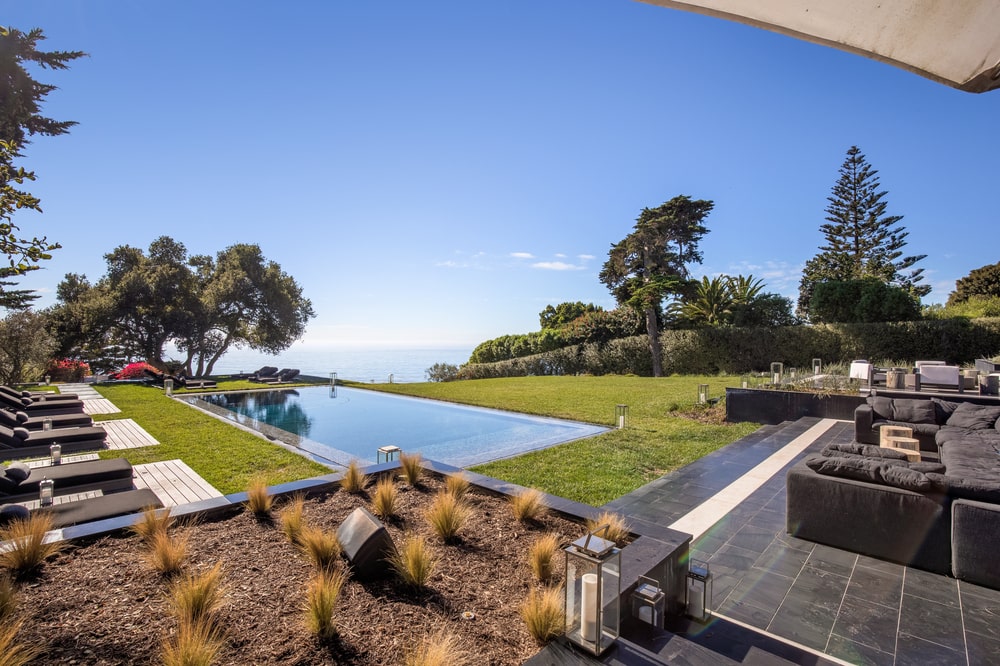 This is another view of the swimming pool area that showcases the landscape and the view. Image courtesy of Toptenrealestatedeals.com.