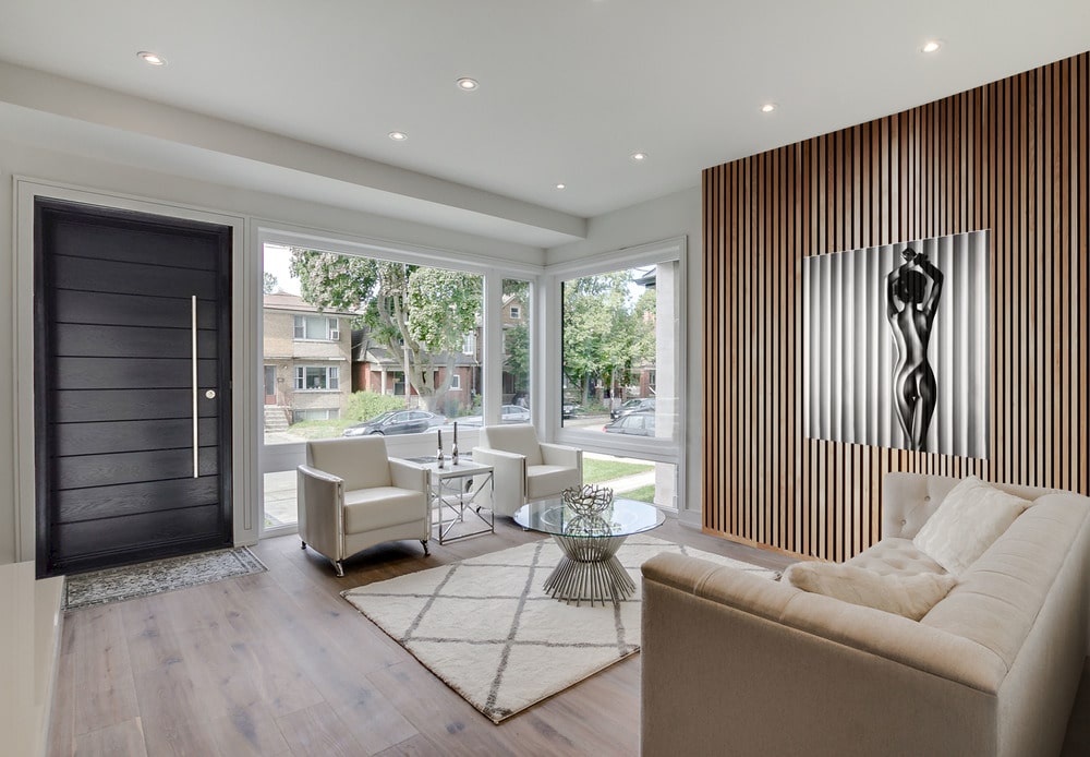 Upon entry into the house, you are welcomed by this simple foyer that leads directly to the living room that has a beige sofa set and a round glass-top coffee table in the middle.