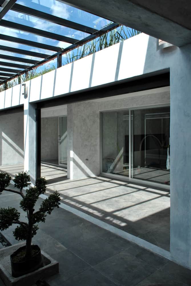 This is another look at the interior courtyard with a covered patio area on the side and a large glass ceiling above.