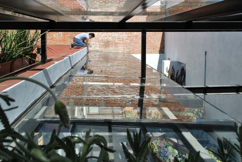 This is another close look at the glass ceiling above the courtyard with a view of the glass ceiling on the trellises of the walkway below.