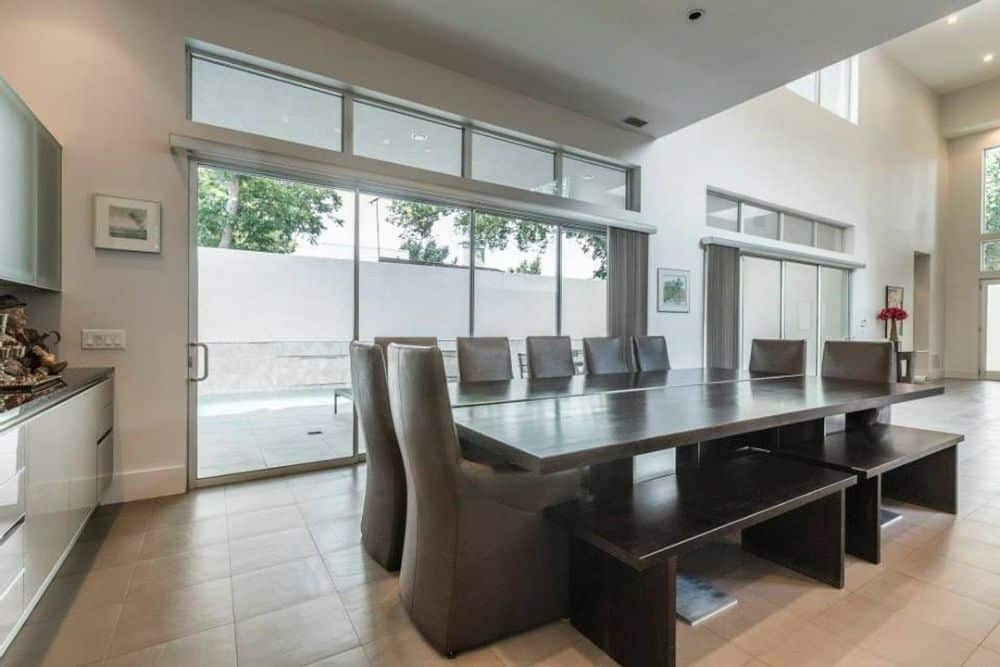 Dining area with leather chairs, a dark wood table, and matching benches.