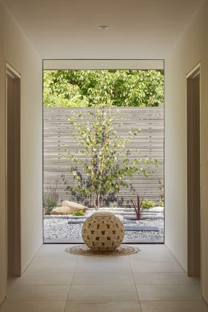 The interior shot of the portion of the hallway shows a small open space outside with ornaments.