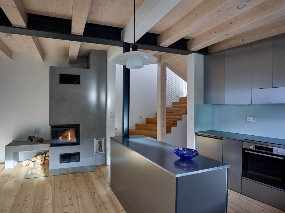 Interior shot in kitchen area showcasing its hanging lights and gray kitchen accents.