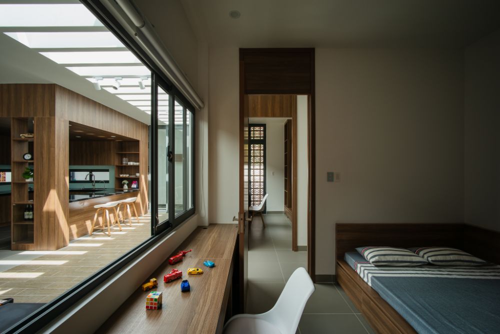 Bedroom with open sliding window leading to view the kitchen area.