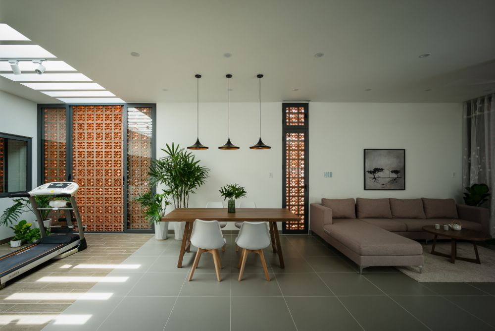 Dining area with four seater table connected to living and exercise area.