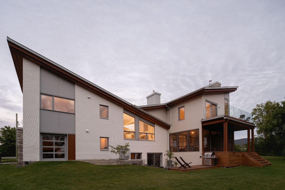 House facade view from outside with cathedral ceiling style surrounded with bermuda grass.