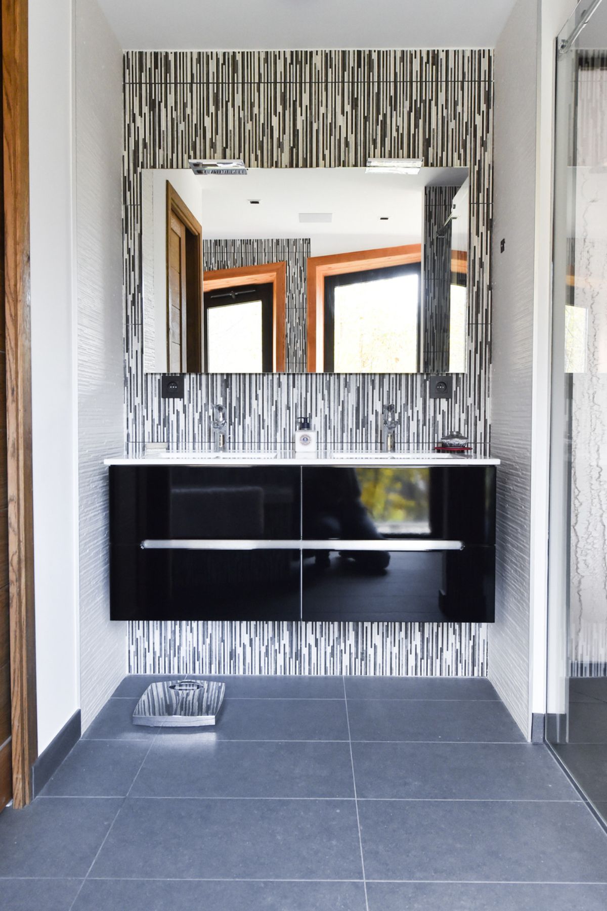 Bathroom area features the tile-topped bathroom sink and full-width mirror.