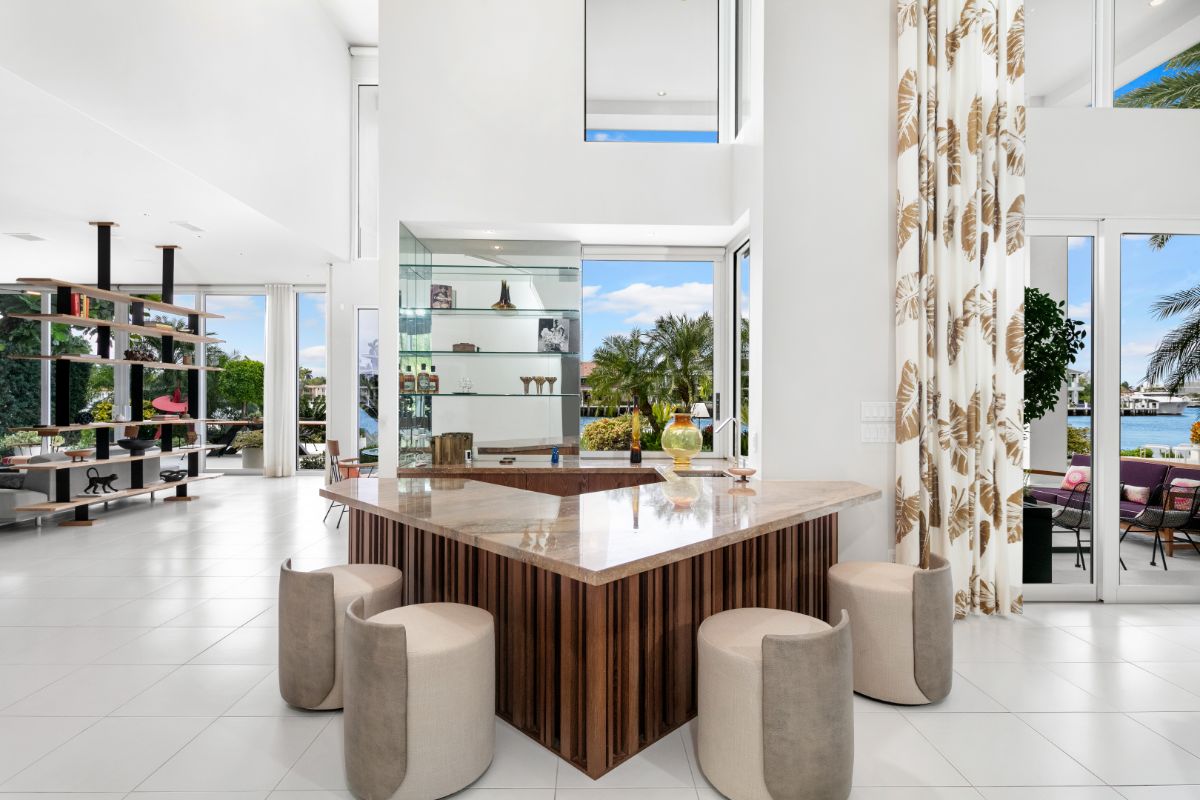 Two story bar area with customized wooden marble topped bar table.