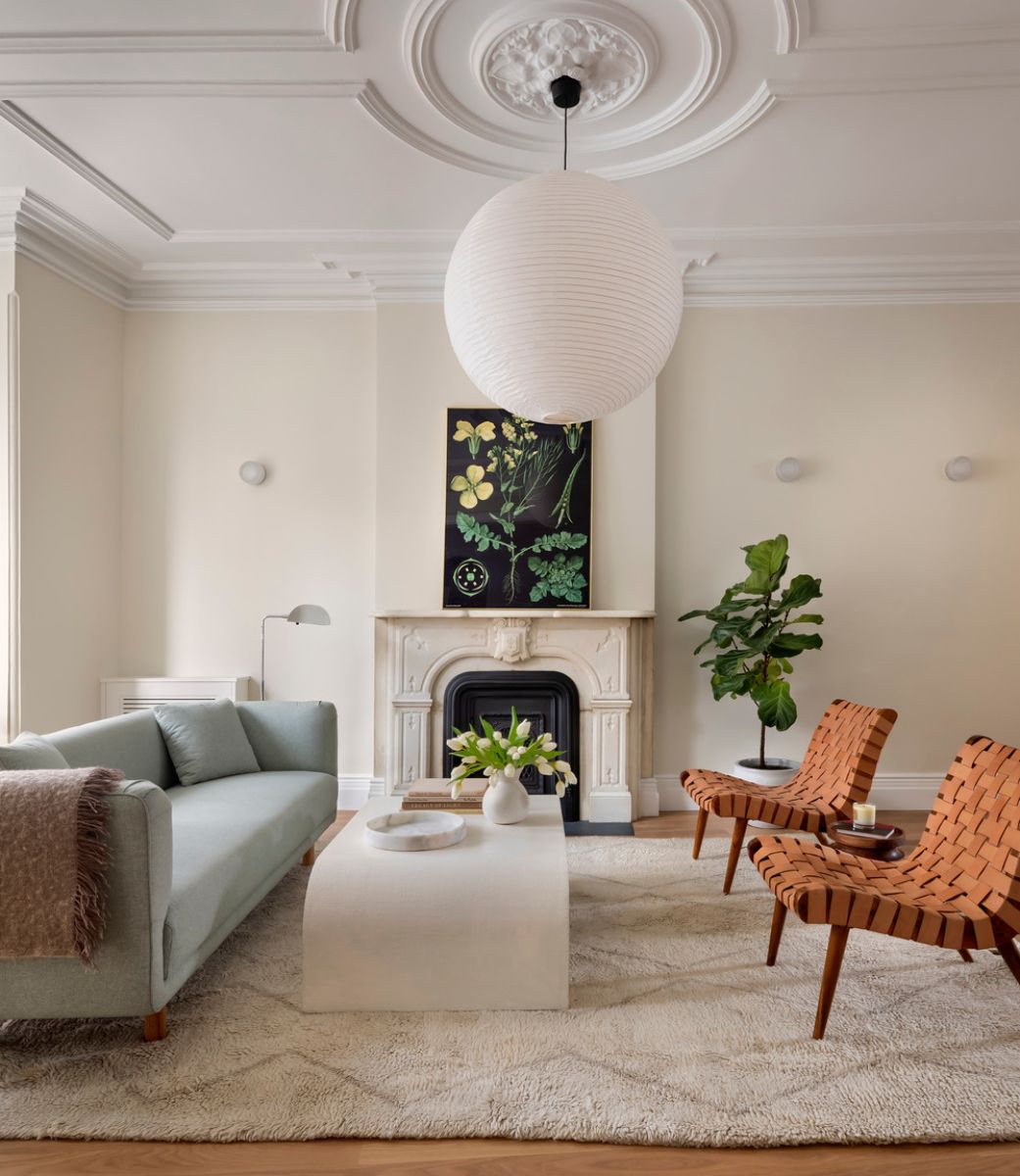 A close-up of the living room that features the fireplace mantel and big ball lighting.