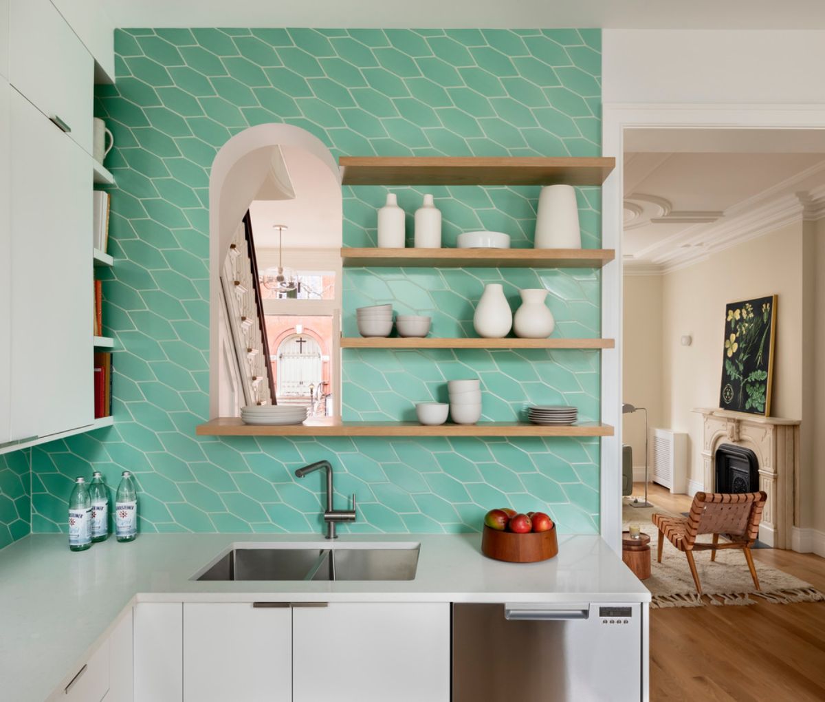 The kitchen features a picket-style bright green Fireclay tile with open white oak shelving.