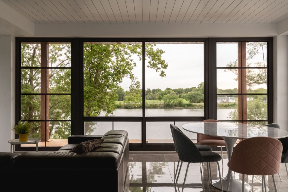 Solarium with large windows allowing to gaze out at the flowing river.