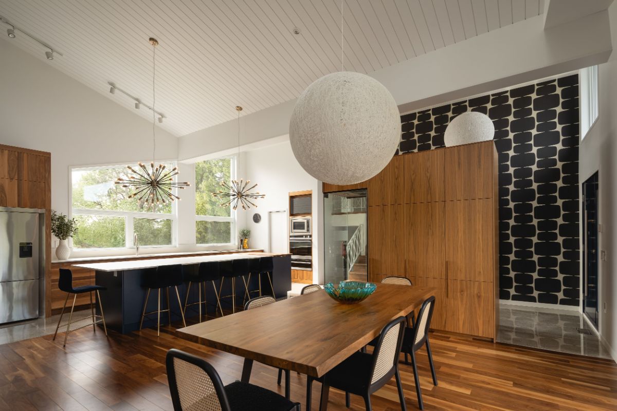 The kitchen with an imposing central island, and connected to dining area.